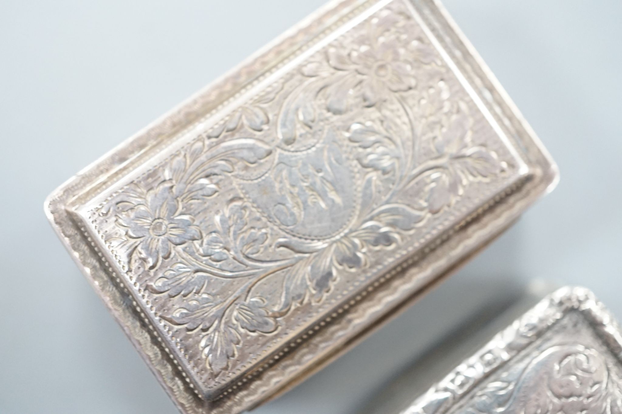 A George IV engraved silver rectangular vinaigrette, by Nathaniel Mills, Birmingham, 1827, engraved 'Celia', 31mm and a later vinaigrette, Birmingham, 1833.